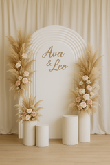 Triple ripple arch panel with neutral dried floral styling and plinths, displayed outdoors on brick paving for wedding decor