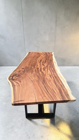 Handcrafted live edge Suar wood dining table measuring 2100 x 1000mm with natural timber grain and optional black steel or solid timber legs.