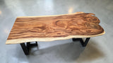 Solid Suar live edge dining table featuring natural wood grain and modern powder-coated steel base