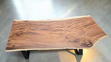 Handcrafted live edge Suar wood dining table measuring 2100 x 1000mm with natural timber grain and optional black steel or solid timber legs.